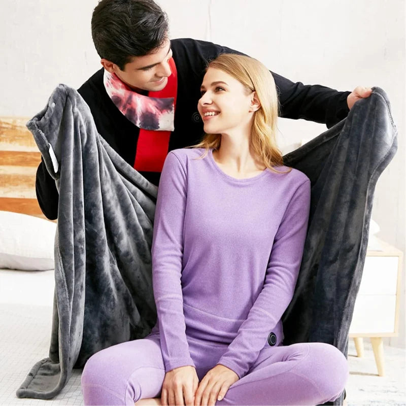 Couple sous le plaid chauffant gris