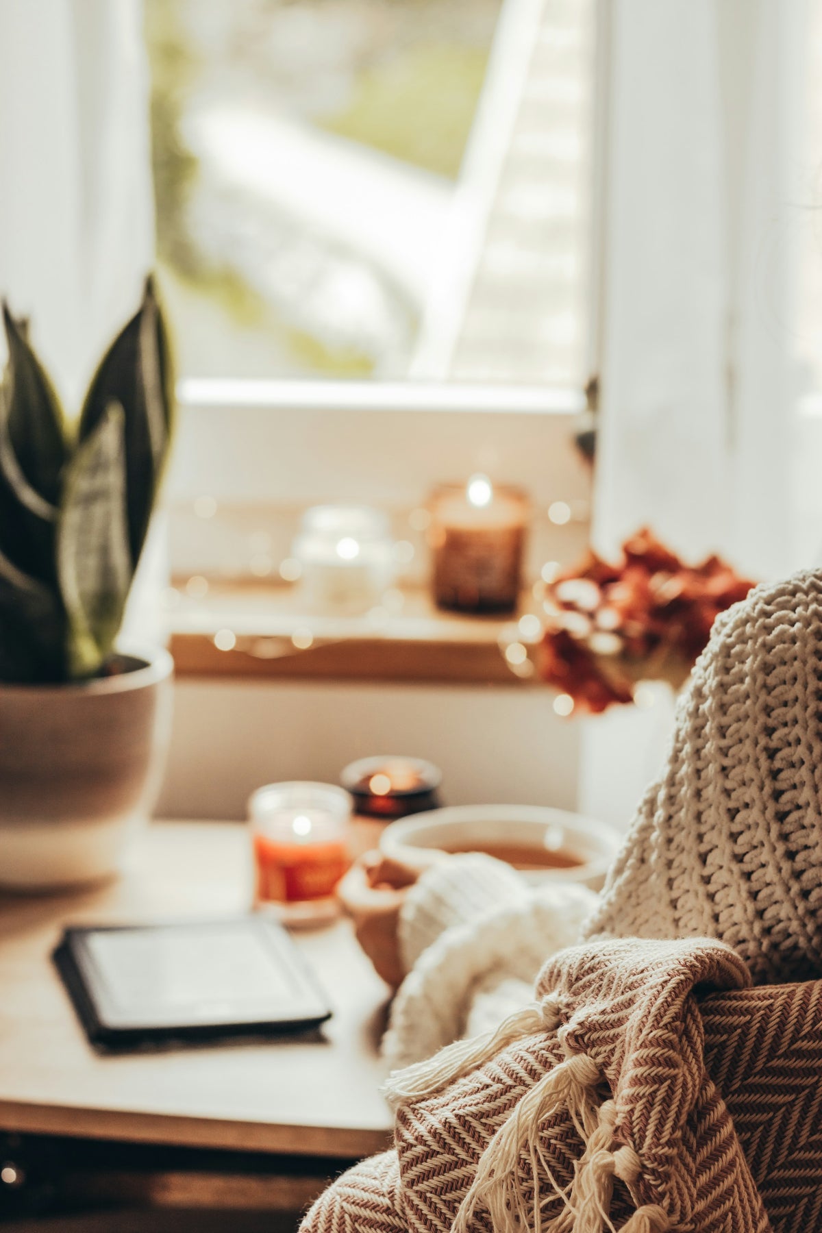 Moment cocooning avec une tasse chaude et des bougies